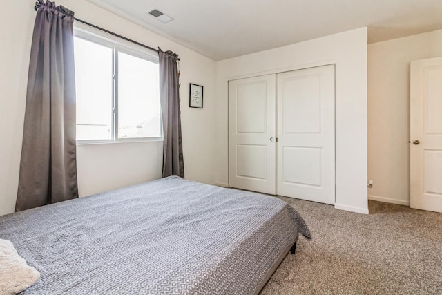 bedroom with carpet flooring and a closet