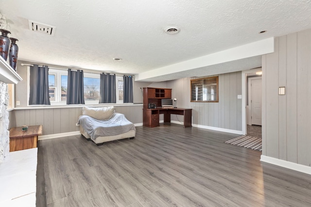 living room with hardwood / wood-style floors and a textured ceiling