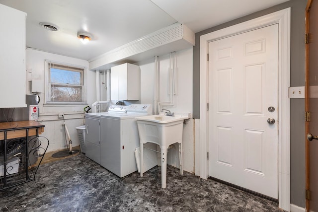 laundry room featuring cabinets and washer and dryer