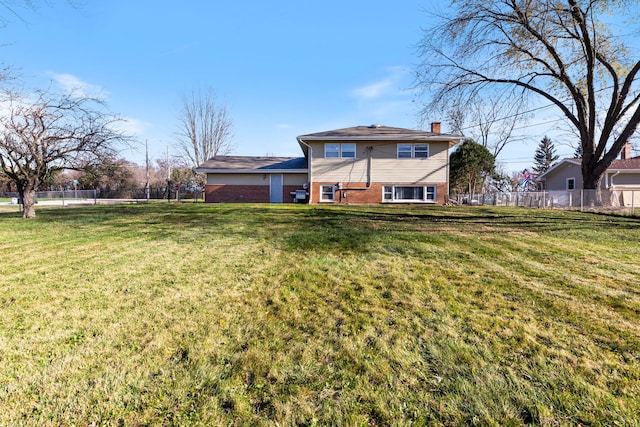 rear view of house featuring a lawn