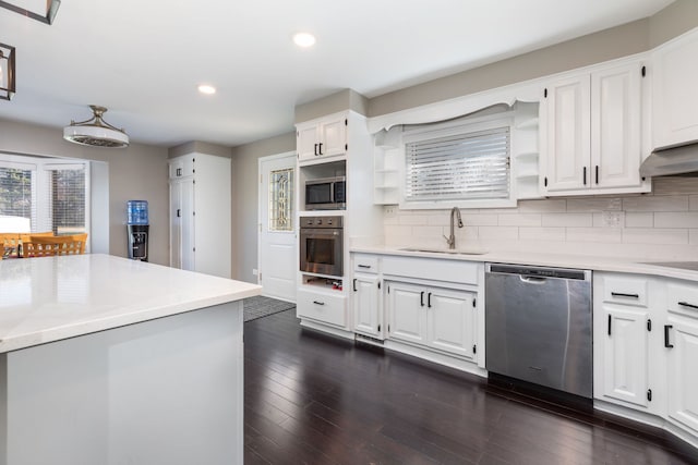 kitchen with stainless steel appliances, white cabinetry, and sink