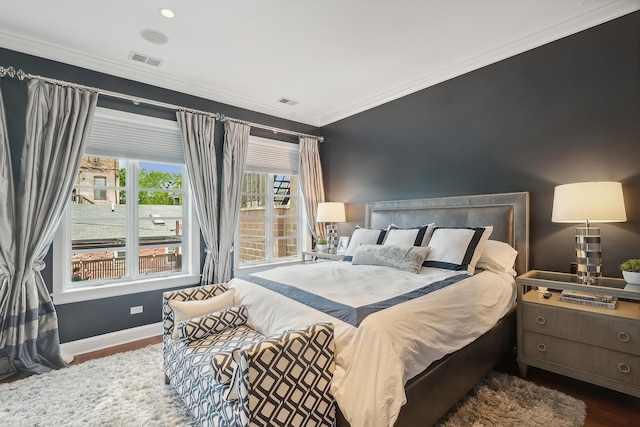 bedroom featuring crown molding and dark wood-type flooring