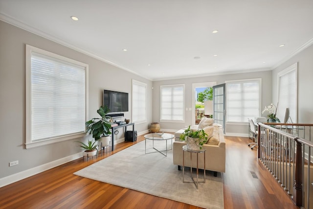 living room featuring light hardwood / wood-style floors and crown molding