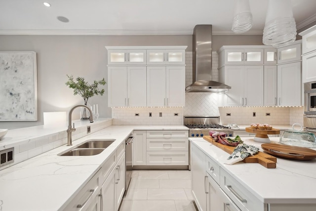 kitchen featuring white cabinets, wall chimney range hood, and sink