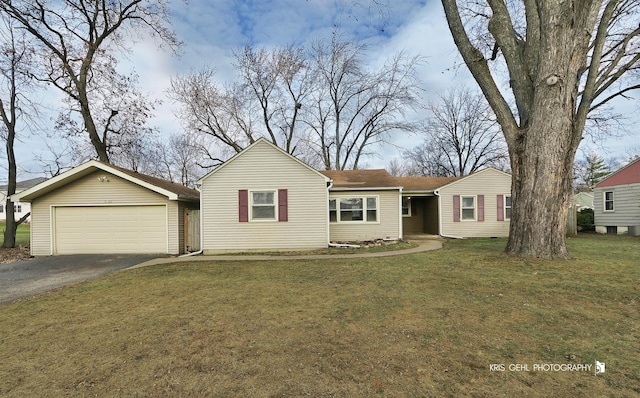 single story home featuring a front lawn and a garage