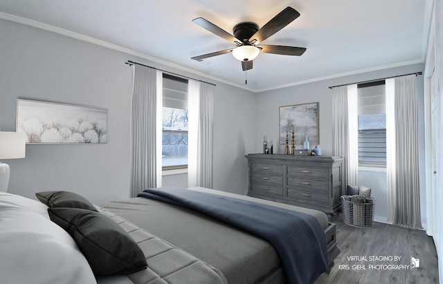 bedroom featuring hardwood / wood-style flooring, ceiling fan, and ornamental molding