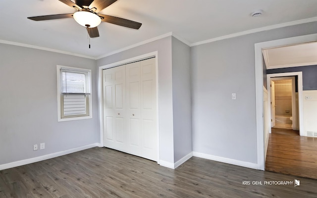 unfurnished bedroom with ceiling fan, a closet, crown molding, and dark hardwood / wood-style floors