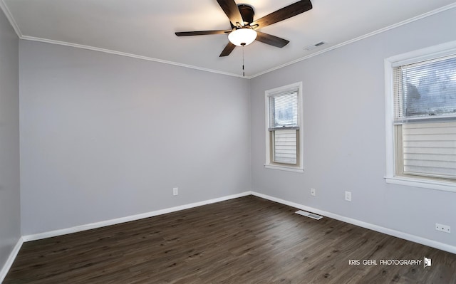 spare room with dark hardwood / wood-style flooring, crown molding, and a healthy amount of sunlight