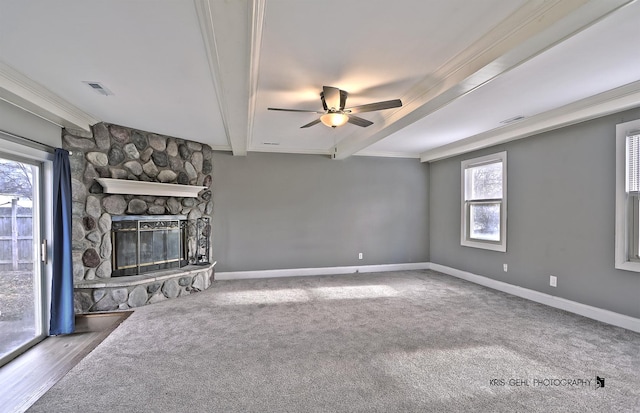 unfurnished living room featuring a fireplace, carpet, a wealth of natural light, and crown molding