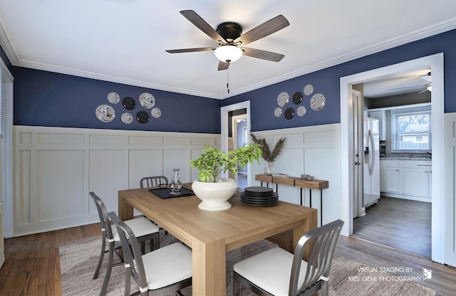 dining area featuring ceiling fan, wood-type flooring, and ornamental molding