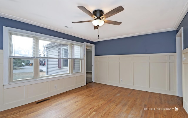 unfurnished bedroom featuring ceiling fan, light hardwood / wood-style flooring, and crown molding