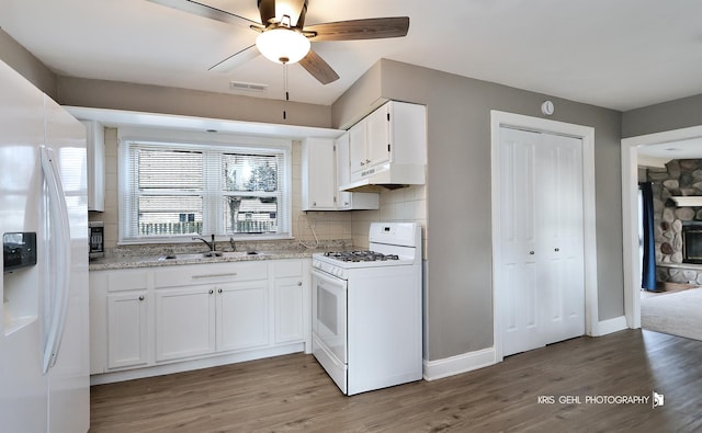 kitchen featuring sink, light hardwood / wood-style flooring, white appliances, white cabinets, and custom range hood