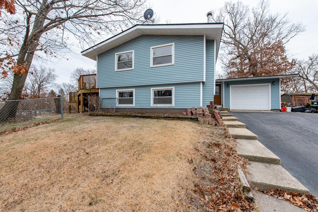 view of front of property with a garage and a front lawn