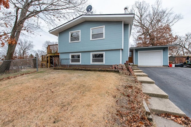 view of front of property with a garage and a front lawn