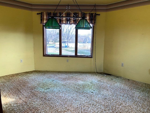 unfurnished dining area featuring carpet flooring and ornamental molding