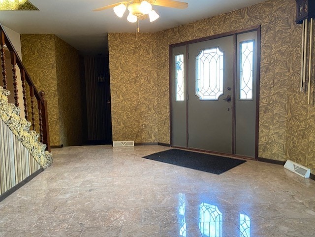 entrance foyer with ceiling fan