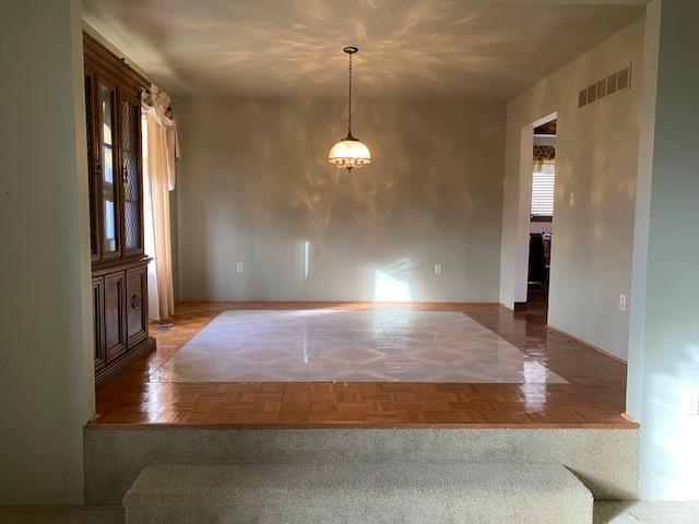 unfurnished dining area featuring parquet floors