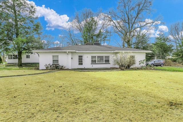 rear view of house featuring a yard