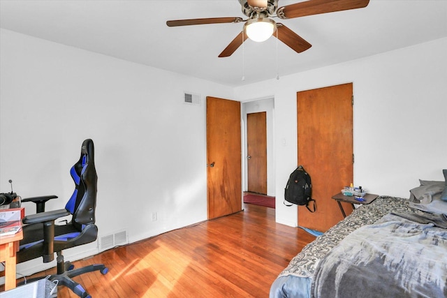 bedroom with wood-type flooring and ceiling fan