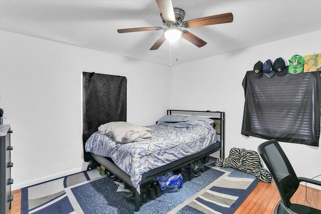 bedroom featuring hardwood / wood-style flooring and ceiling fan