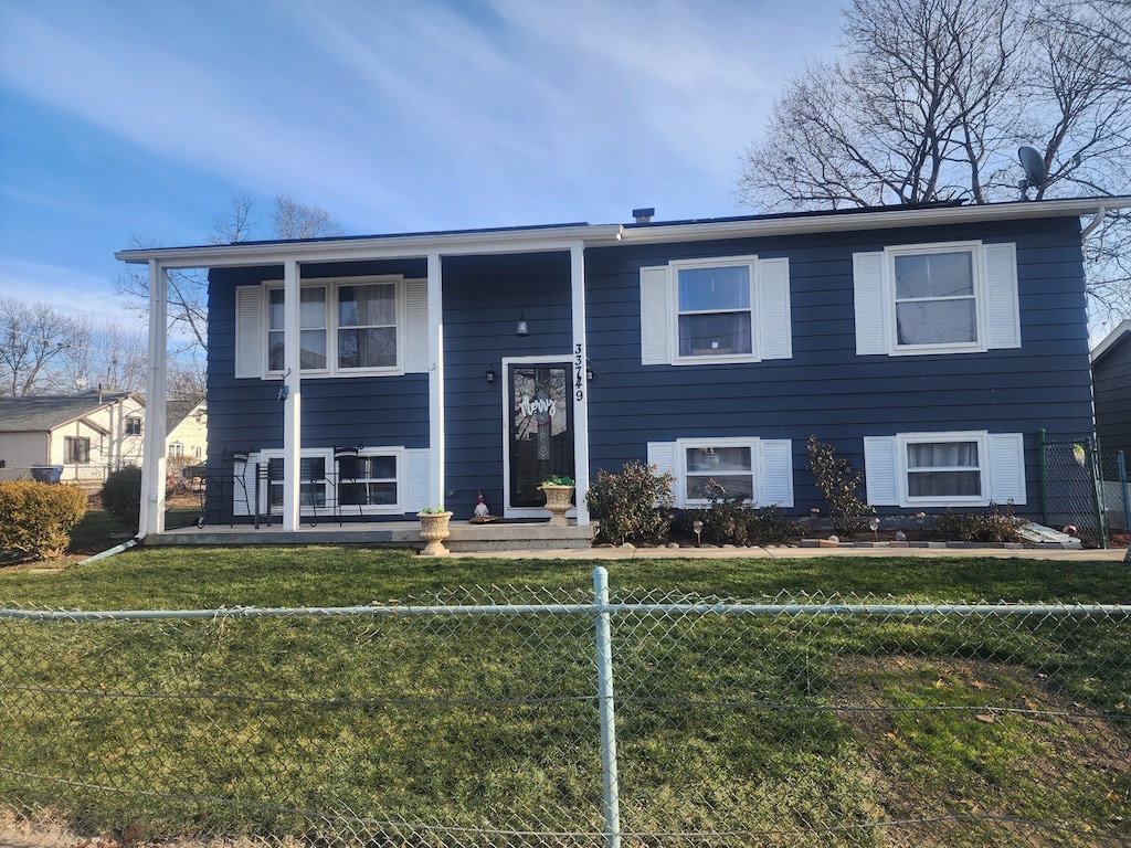 raised ranch with a front lawn