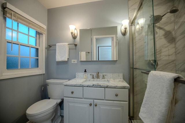 bathroom with vanity, an enclosed shower, and toilet