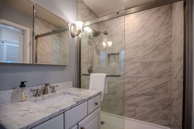 bathroom featuring vanity and a shower with shower door