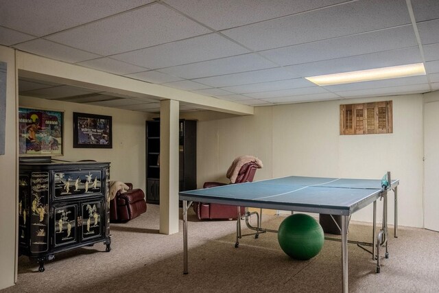 recreation room featuring carpet flooring and a paneled ceiling