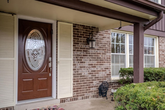 view of exterior entry featuring covered porch