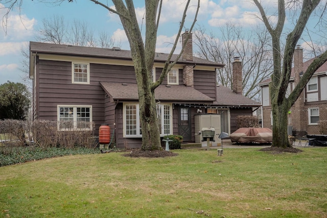 rear view of property with a yard