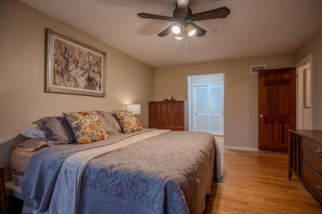 bedroom featuring ceiling fan, a closet, and light hardwood / wood-style floors