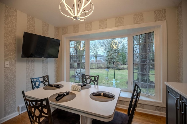 dining room with hardwood / wood-style floors, a chandelier, and plenty of natural light