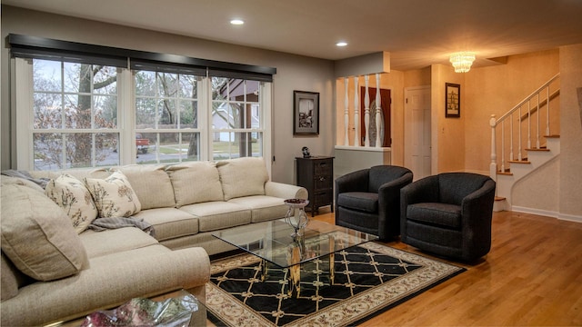 living room with hardwood / wood-style floors, a healthy amount of sunlight, and a notable chandelier