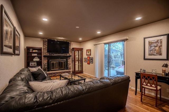 living room featuring a fireplace and light hardwood / wood-style flooring