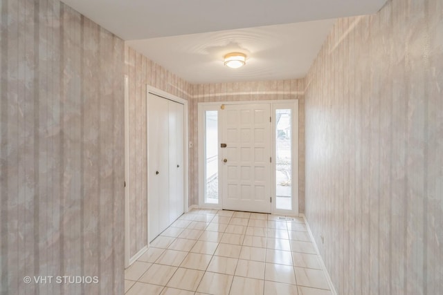 foyer entrance with light tile patterned floors