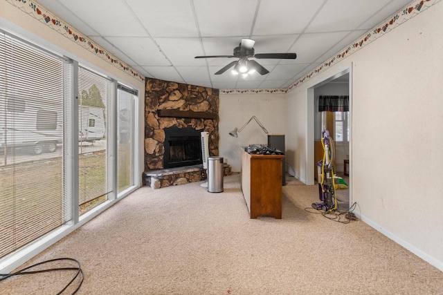 living room featuring carpet floors, a wealth of natural light, and a paneled ceiling