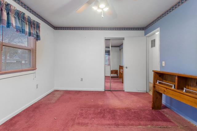 carpeted bedroom featuring ceiling fan and a closet