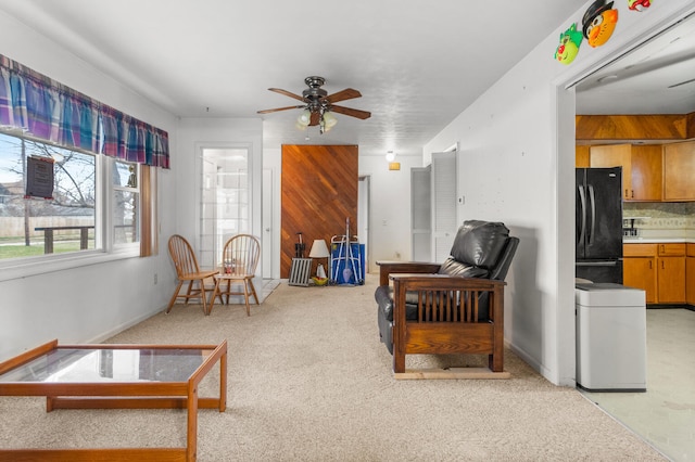 living room with ceiling fan and light carpet