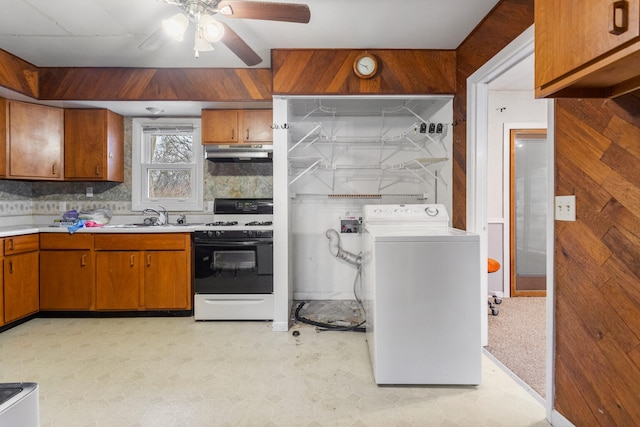 kitchen with sink, ceiling fan, decorative backsplash, white gas range, and washer / clothes dryer