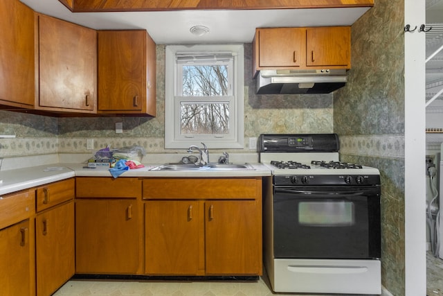 kitchen featuring white range with gas cooktop and sink