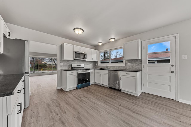 kitchen featuring white cabinetry, plenty of natural light, and stainless steel appliances