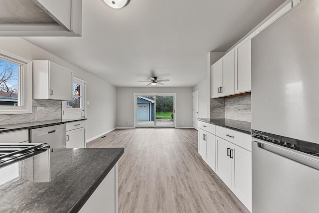 kitchen featuring stainless steel fridge, light wood-type flooring, white cabinetry, and ceiling fan