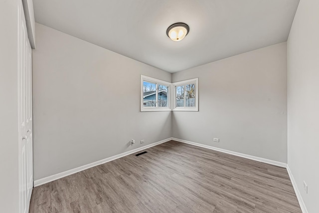 spare room featuring hardwood / wood-style flooring