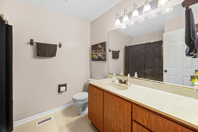 bathroom with tile patterned floors, vanity, and toilet