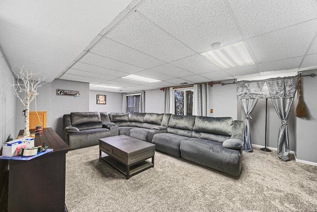 living room with carpet and a paneled ceiling