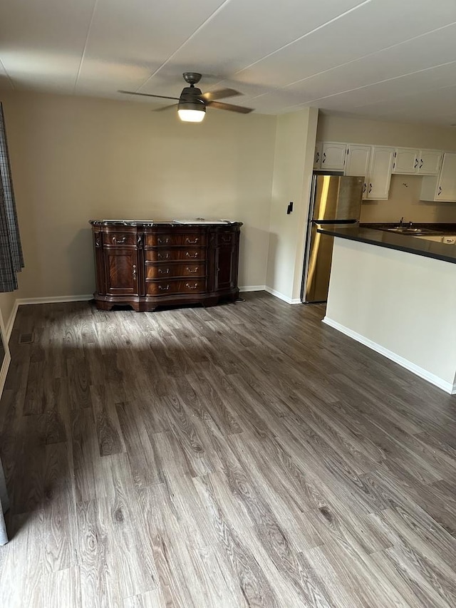 unfurnished living room featuring hardwood / wood-style flooring and ceiling fan