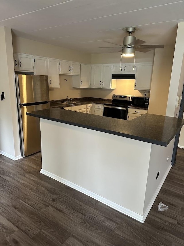 kitchen featuring dark hardwood / wood-style flooring, white cabinetry, and stainless steel appliances