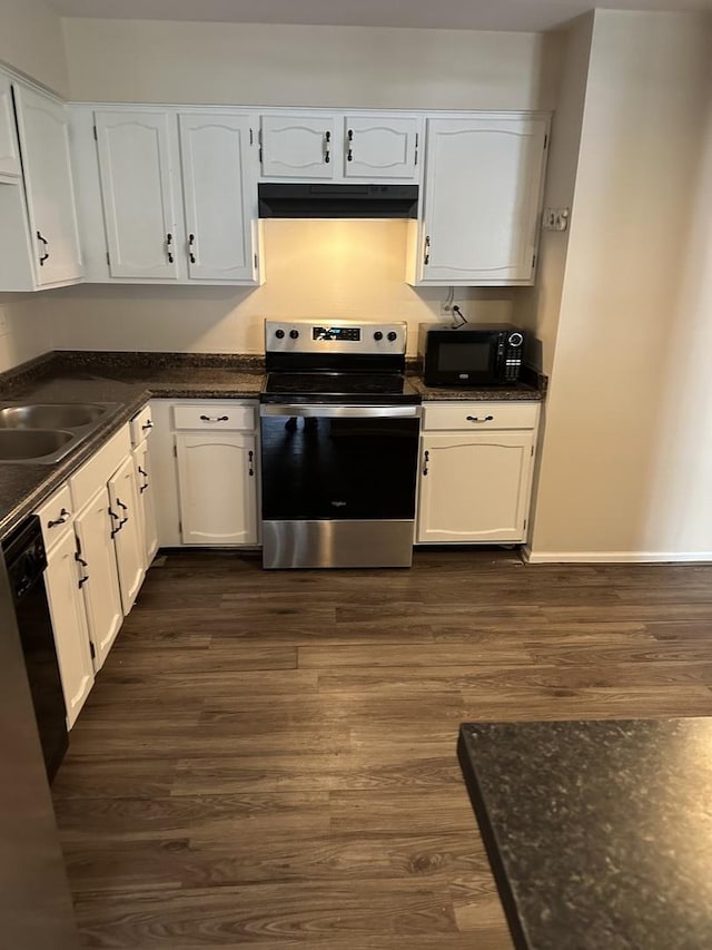 kitchen with dark hardwood / wood-style flooring, dark stone counters, sink, black appliances, and white cabinets