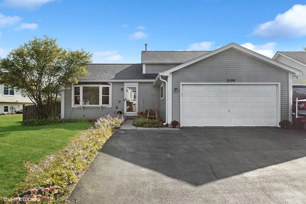 view of front of property featuring a garage and a front yard