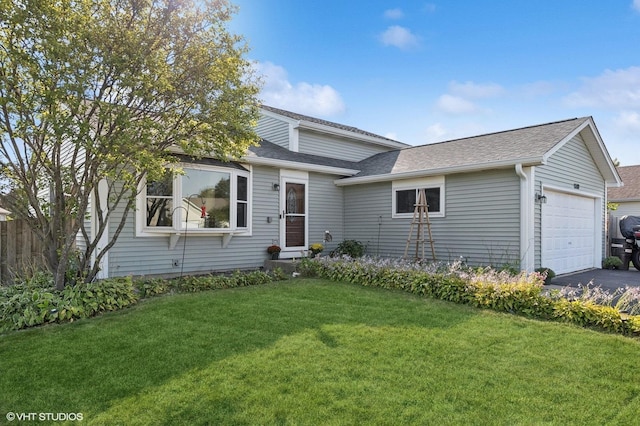 view of front of property featuring a garage and a front lawn